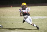 Lemoore's Corey Whitmore puts the Tigers ahead in Friday's 48-14 victory over the Pioneers Friday night in Visalia.